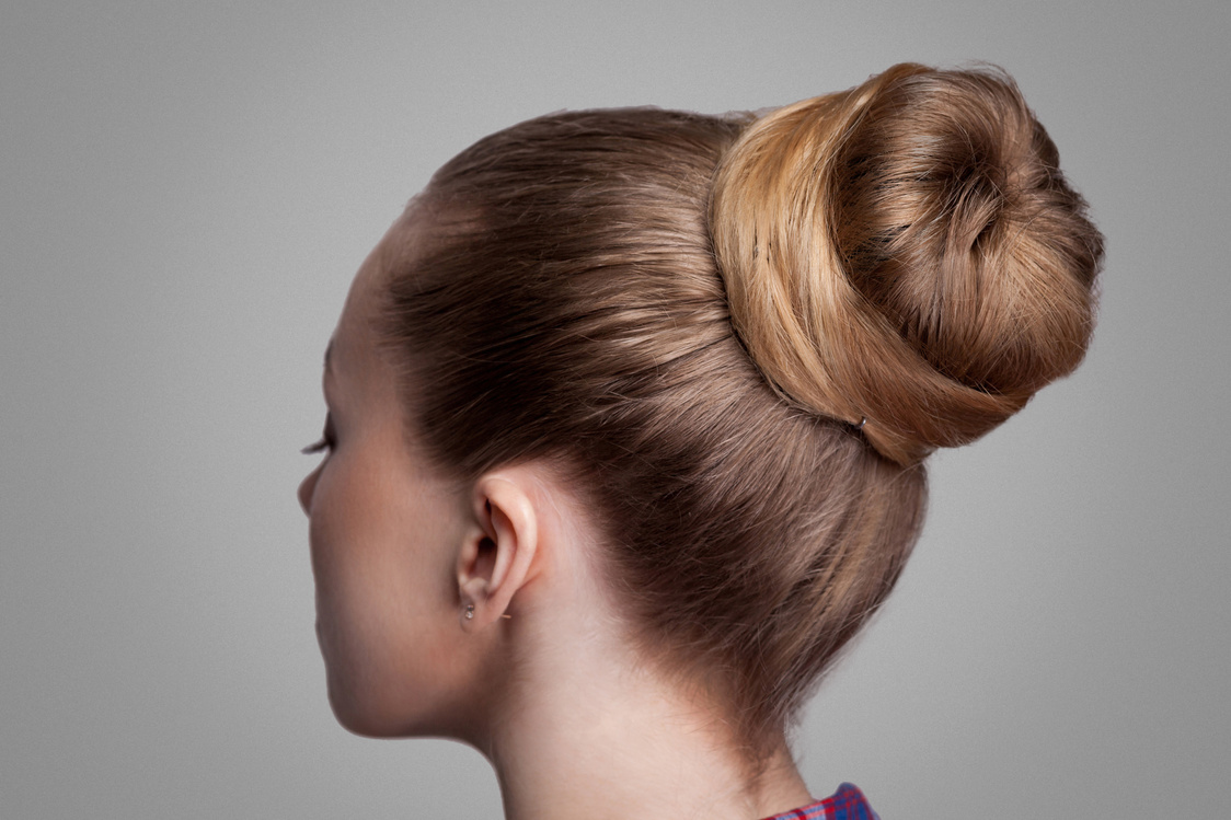 Profile Side View Closeup of Woman with Creative Elegant Brown Collected Hairstyle, Bun Hair.